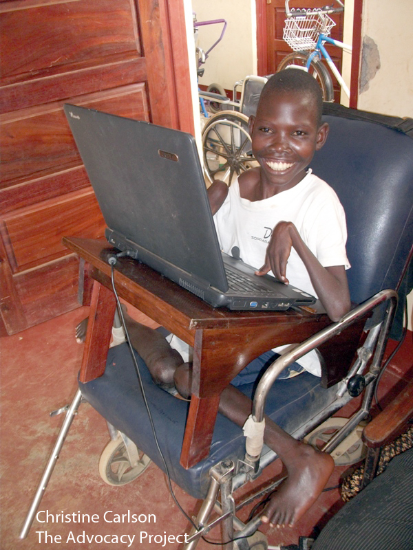 Boy smiling with computer